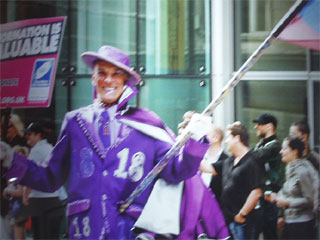 Detail of a picture of a Pride marcher dressed in purple