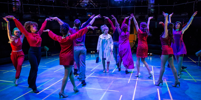 The entire Sweet Charity cast, with Kaisa Hammarlund as Charity Hope Valentine in the centre (Royal Exchange Production photo by Richard Davenport)