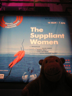 Mr Monkey looking at the poster for The Suppliant Women