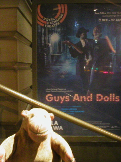 Mr Monkey looking at the poster for Guys and Dolls
