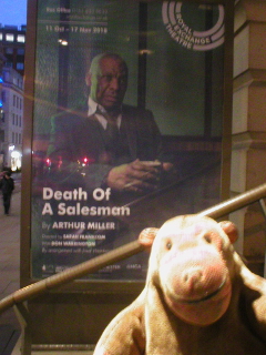 Mr Monkey looking at the poster for Death of a Salesman