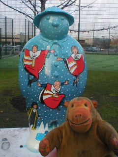 Mr Monkey looking at the Ten Lords a-Leaping snowman