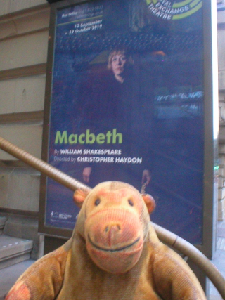 Mr Monkey looking at the poster for Macbeth