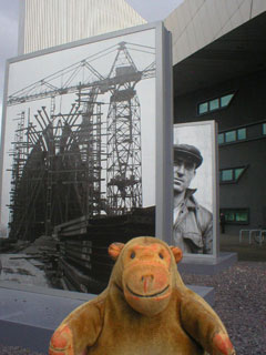 Mr Monkey looking at giant prints of Cecil Beaton's pictures of Tyneside shipyards