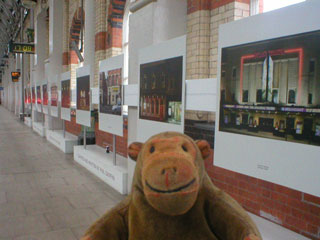 Mr Monkey looking at the Night and Day exhibition on platform 12