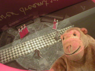 Mr Monkey examining the model stage set in the Education Lounge