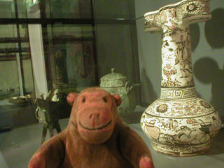 Mr Monkey looking at a Ming dynasty stoneware arrow pot