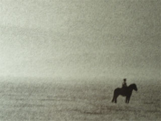 A tiny horse and rider in Ragnar Axelsson's landscape photo