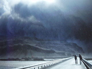 Two people walking towards an ash cloud in Anna Maria Sigurjondottir's photo