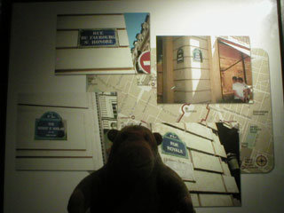Mr Monkey looking at snapshots of Paris by Greg Hersov