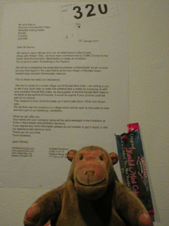 Mr Monkey looking at a letter written to Romney's of Kendal