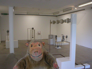 Mr Monkey looking at the Self Portrait With Two Circles series of sculptures by Kit Craig