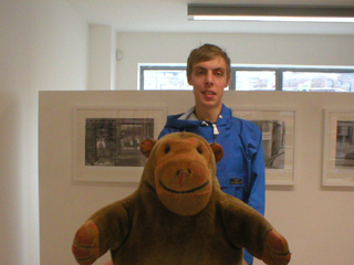 Mr Monkey with Alexander Marrs standing in front of his photos