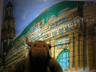 Mr Monkey looking at a coloured picture of the outside of the Exchange by Michael Morrell