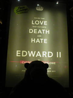 Mr Monkey looking at the Love Hate Death poster inside the theatre
