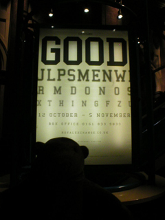 Mr Monkey looking at the GOOD poster inside the theatre