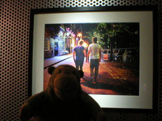 Mr Monkey looking at at a photo of two men holding hands 