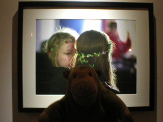 Mr Monkey looking at a photo of two girls embracing