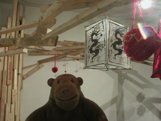 Mr Monkey looking at dragon lanterns hanging from the wishing tree