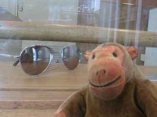 Mr Monkey looking at a pair of unwearable sunglasses
