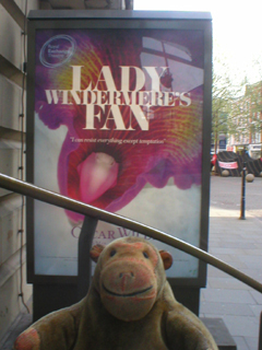 Mr Monkey looking at the Lady Windermere's Fan poster outside the theatre