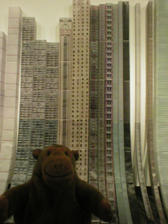 Mr Monkey looking at tracing paper skyscrapers by Han Feng