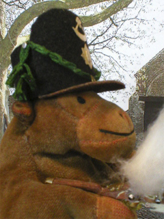 Mr Monkey wearing his Belgic shako and firing his musket outside Hougoumont
