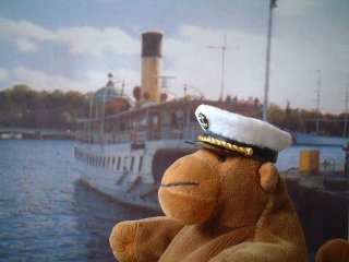 Captain Monkey in front of a ferry in Stockholm