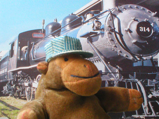 Monkey standing in front of his railroad locomotive