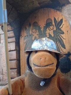 Mr Monkey guarding a door in his kettle hat