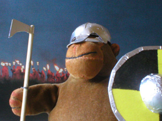 Monkey in his Viking helmet, with a torchlit procession behind him
