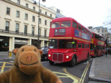 Mr Monkey looking at a Routemaster bus on the Strand