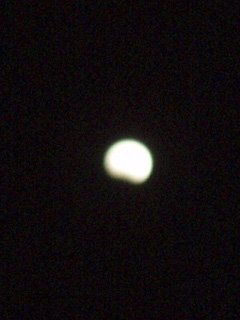 The moon at twenty to ten, with a small shadow at the bottom