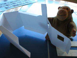 Mr Monkey folding the cut out building