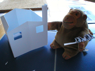 Mr Monkey adding figures to the outside of the building