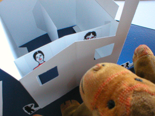 Mr Monkey looking at the crude copies of Portrait of Ann and the Head of a Man inside the building