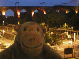 Mr Monkey watching the Scarborough Flyer cross Stockport viaduct at night