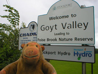 Mr Monkey reading the signs outside the site.