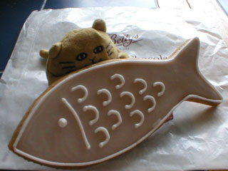 Mr Cat finding out that he doesn't like the taste of a gingerbread fish