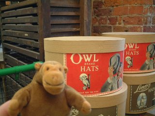 Mr Monkey next to an Owl Brand hatbox