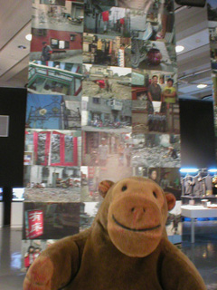 Mr Monkey in front of a banner made of pictures of China