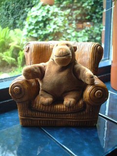 Mr Monkey seated in an armchair