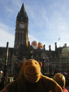 Mr Monkey looking at Santa Claus atop Manchester town hall