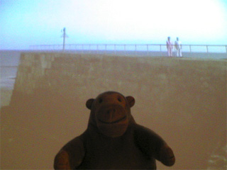 Mr Monkey in front of a Conroy/Sanderson Cockermouth picture