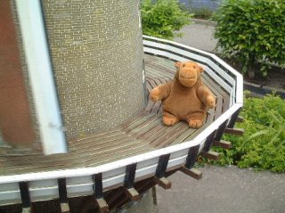 Mr Monkey on the walkway around a windmill