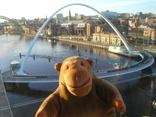 Mr Monkey looking down at the Millennium Bridge from the BALTIC outdoor viewing platform
