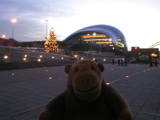 Mr Monkey looking across the Millennium Square at dusk
