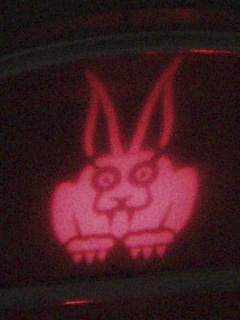 A Vampire Rabbit looking down from a window