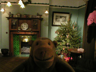 Mr Monkey looking at the Edwardian room decorated for Christmas