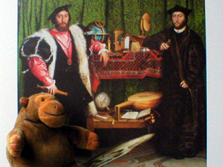 Mr Monkey in front of a print of the Ambassadors